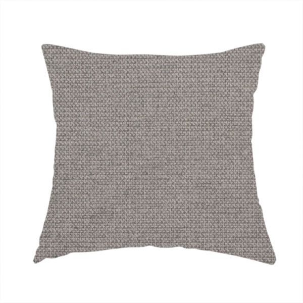 The fabric used to create this handmade cushion is a textured light grey fabric with a tight, uniform cross-weave.