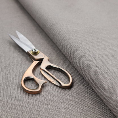A textured light grey fabric with a tight, uniform cross-weave.