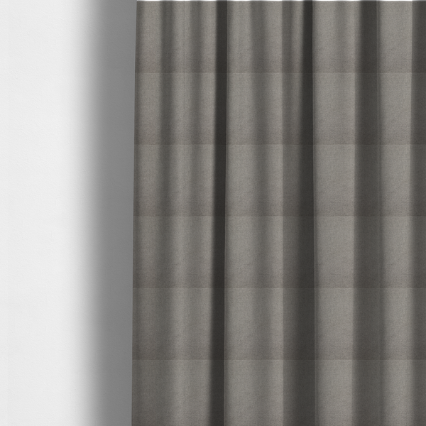 The fabric used to create these made-to-measure curtains is a textured light grey fabric with a tight, uniform cross-weave.