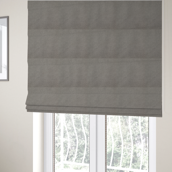The fabric used to create these Roman blinds is a textured light grey fabric with a tight, uniform cross-weave.