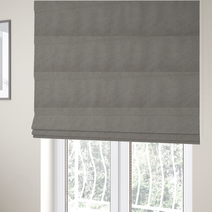 The fabric used to create these Roman blinds is a textured light grey fabric with a tight, uniform cross-weave.