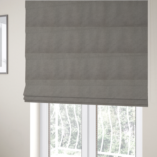 The fabric used to create these Roman blinds is a textured light grey fabric with a tight, uniform cross-weave.