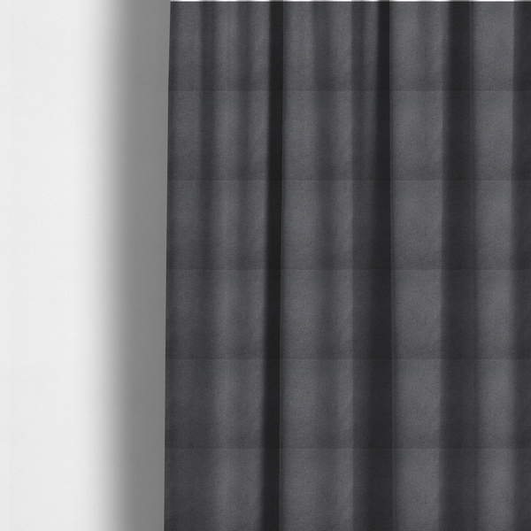The fabric used to create these made-to-measure curtains is a textured charcoal grey fabric with a tight, uniform cross-weave.