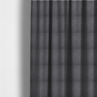 The fabric used to create these made-to-measure curtains is a textured charcoal grey fabric with a tight, uniform cross-weave.