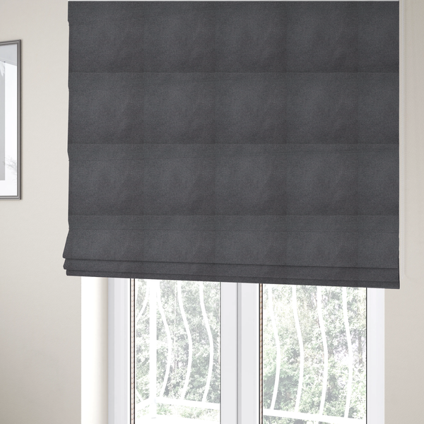 The fabric used to create these Roman blinds is a textured charcoal grey fabric with a tight, uniform cross-weave.