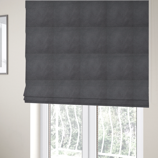The fabric used to create these Roman blinds is a textured charcoal grey fabric with a tight, uniform cross-weave.