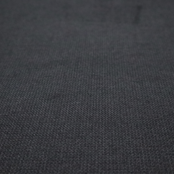 A textured near-black fabric with a tight, uniform cross-weave.