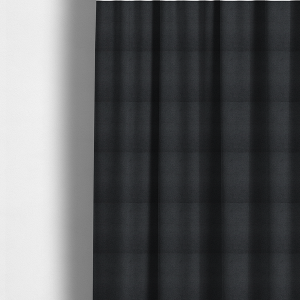 The fabric used to create these made-to-measure curtains is a textured near-black fabric with a tight, uniform cross-weave.