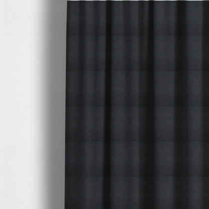 The fabric used to create these made-to-measure curtains is a textured near-black fabric with a tight, uniform cross-weave.