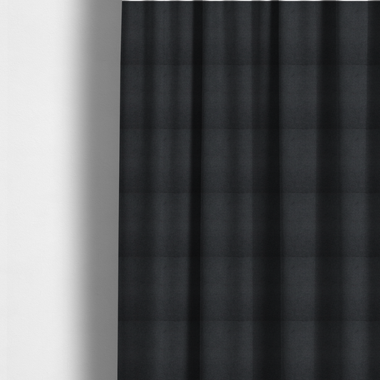 The fabric used to create these made-to-measure curtains is a textured near-black fabric with a tight, uniform cross-weave.