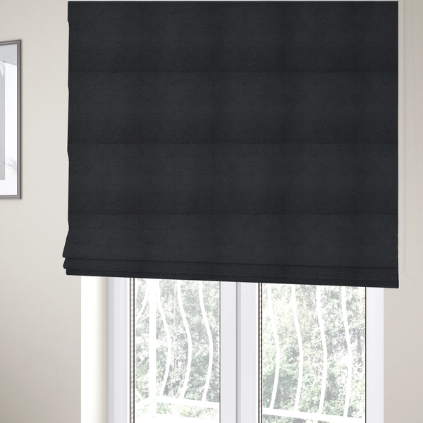 The fabric used to create these Roman blinds is a textured near-black fabric with a tight, uniform cross-weave.