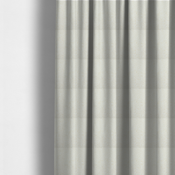 The fabric used to create these made-to-measure curtains is a textured cream and off-white woven fabric.