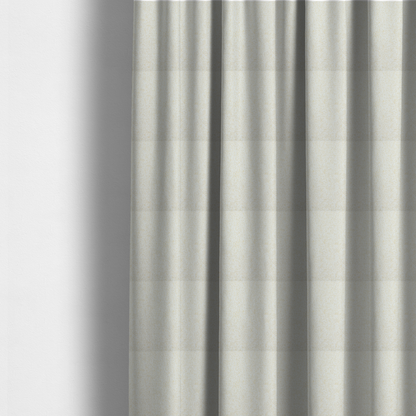 The fabric used to create these made-to-measure curtains is a textured cream and off-white woven fabric.