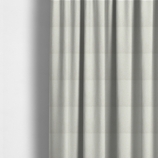 The fabric used to create these made-to-measure curtains is a textured cream and off-white woven fabric.