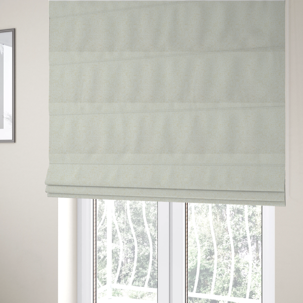 The fabric used to create these Roman blinds is a textured cream and off-white woven fabric.