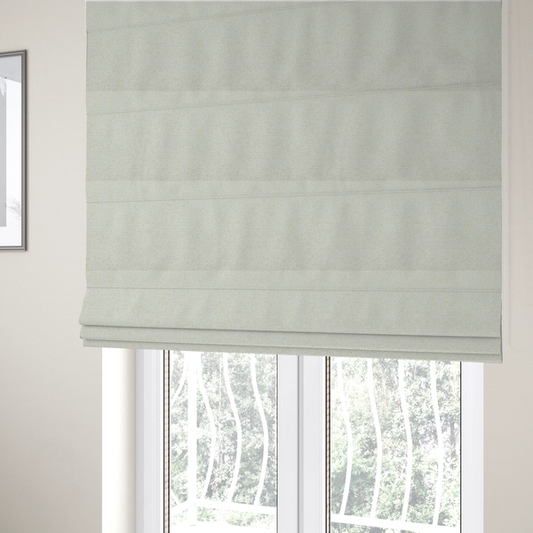 The fabric used to create these Roman blinds is a textured cream and off-white woven fabric.