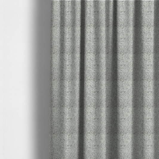 The fabric used to create these made-to-measure curtains is a cream, beige, and charcoal grey woven upholstery fabric swatch.