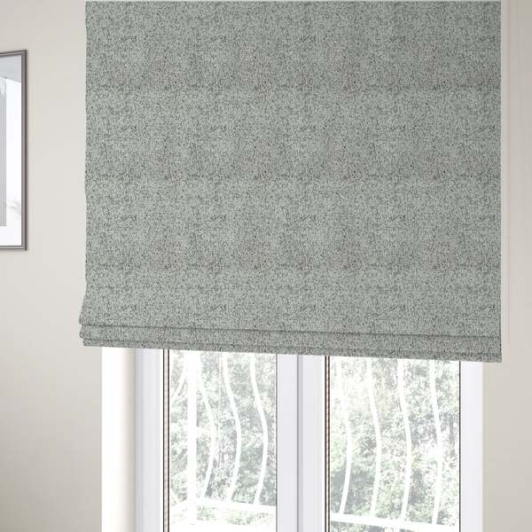 The fabric used to create these Roman blinds is a cream, beige, and charcoal grey woven upholstery fabric swatch.