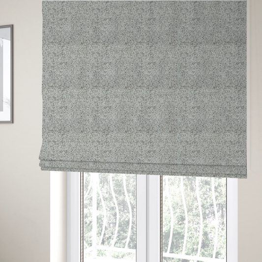 The fabric used to create these Roman blinds is a cream, beige, and charcoal grey woven upholstery fabric swatch.