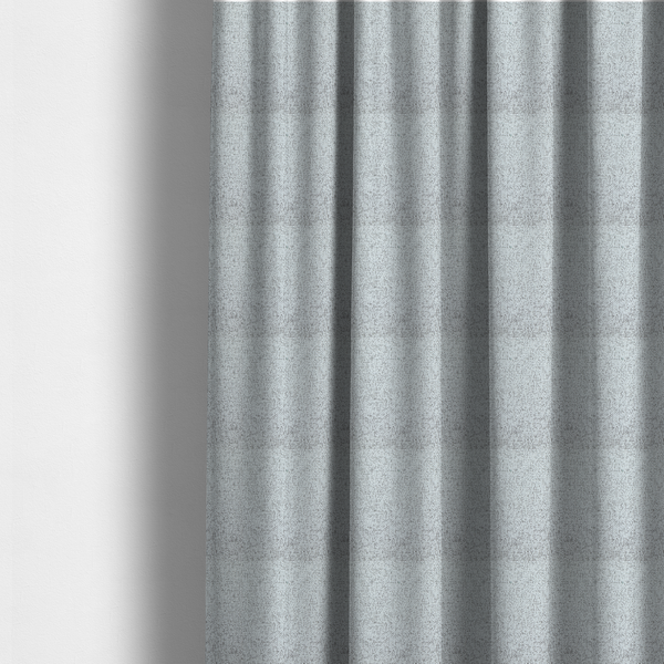 The fabric used to create these made-to-measure curtains is a textured light grey and off-white woven fabric.