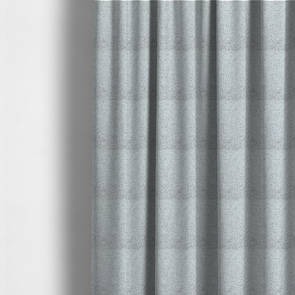 The fabric used to create these made-to-measure curtains is a textured light grey and off-white woven fabric.