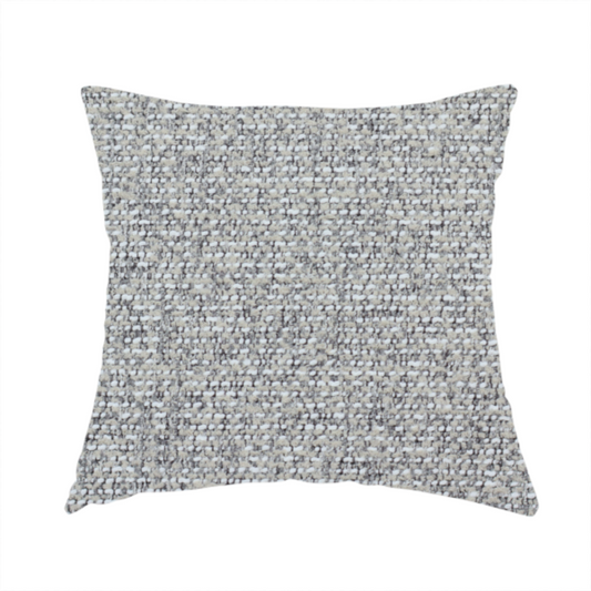 The fabric used to create this handmade cushion is a textured mid-grey and off-white woven fabric.