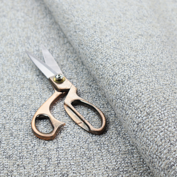A textured mid-grey and off-white woven fabric.