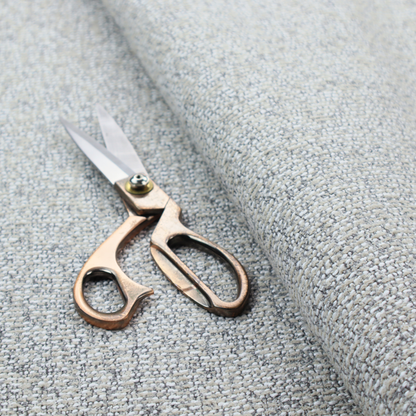 A textured mid-grey and off-white woven fabric.