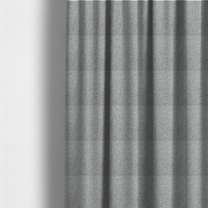 The fabric used to create these made-to-measure curtains is a textured mid-grey and off-white woven fabric.