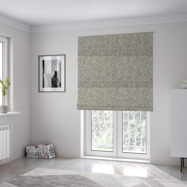 The fabric used to create these Roman blinds is a textured taupe, beige, and charcoal woven fabric swatch.