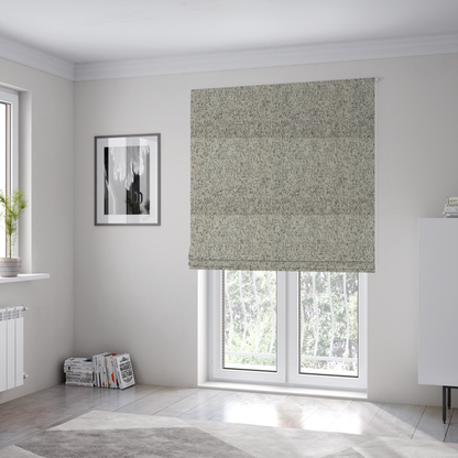 The fabric used to create these Roman blinds is a textured taupe, beige, and charcoal woven fabric swatch.