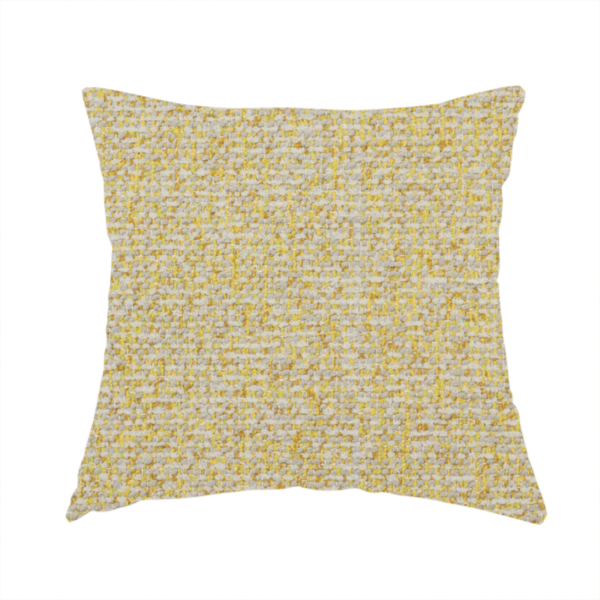 The fabric used to create this handmade cushion is a textured yellow and beige woven fabric.