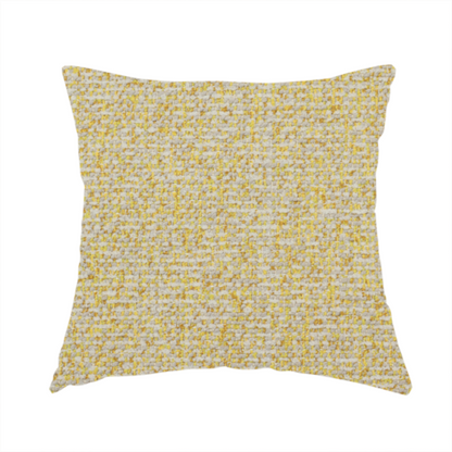 The fabric used to create this handmade cushion is a textured yellow and beige woven fabric.