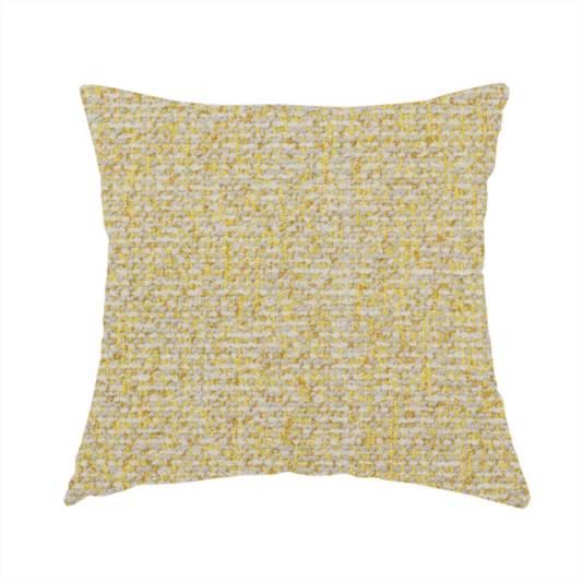 The fabric used to create this handmade cushion is a textured yellow and beige woven fabric.