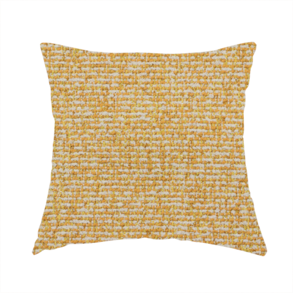 The fabric used to create this handmade cushion is a textured mustard yellow and off-white woven upholstery fabric.