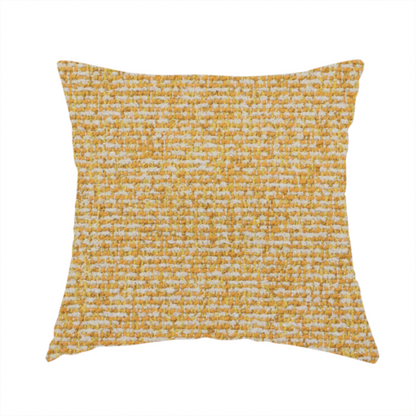 The fabric used to create this handmade cushion is a textured mustard yellow and off-white woven upholstery fabric.