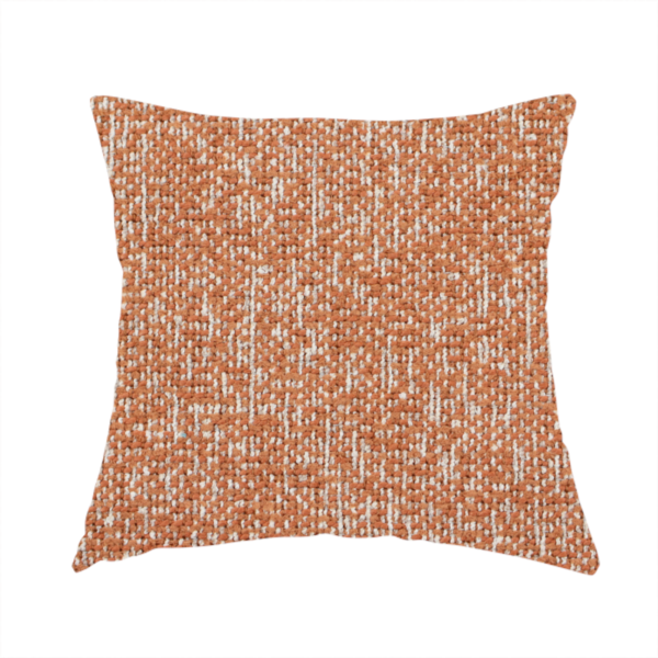 The fabric used to create this handmade cushion is a textured terracotta orange and off-white woven upholstery fabric.