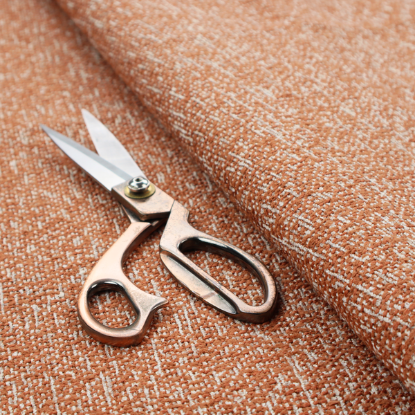 A textured terracotta orange and off-white woven upholstery fabric.