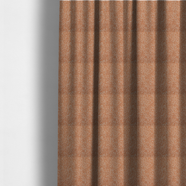 The fabric used to create these made-to-measure curtains is a textured terracotta orange and off-white woven upholstery fabric.