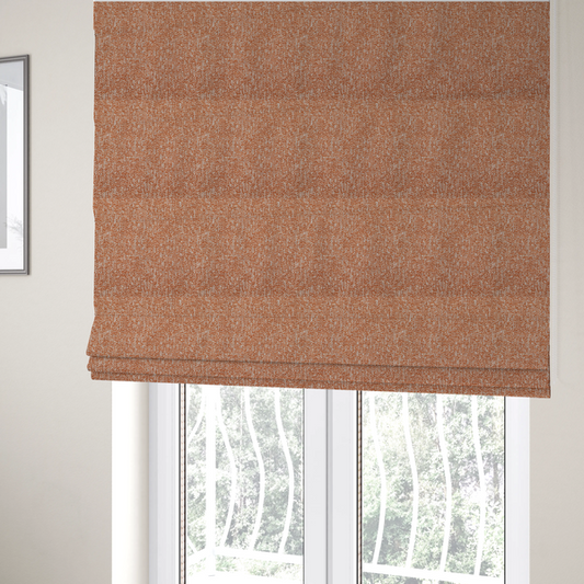 The fabric used to create these Roman blinds is a textured terracotta orange and off-white woven upholstery fabric.