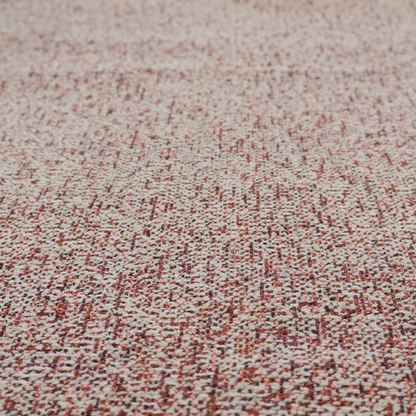 A textured rust red and beige woven upholstery fabric.
