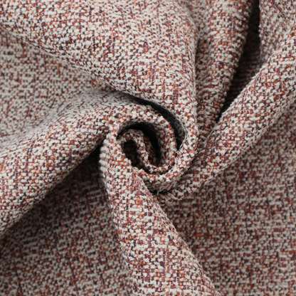 A textured rust red and beige woven upholstery fabric.