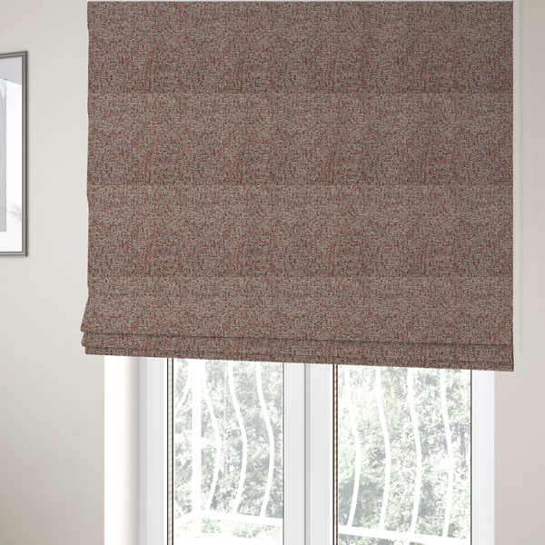 The fabric used to create these Roman blinds is a textured rust red and beige woven upholstery fabric.