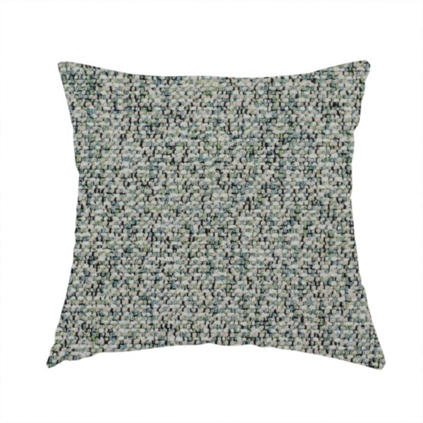 The fabric used to create this handmade cushion is a multi-tonal teal and grey textured woven fabric swatch.