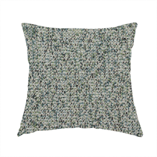 The fabric used to create this handmade cushion is a multi-tonal teal and grey textured woven fabric swatch.