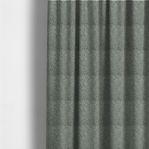 The fabric used to create these made-to-measure curtains is a multi-tonal teal and grey textured woven fabric swatch.