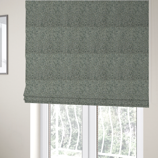 The fabric used to create these Roman blinds is a multi-tonal teal and grey textured woven fabric swatch.