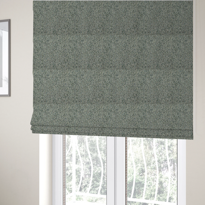 The fabric used to create these Roman blinds is a multi-tonal teal and grey textured woven fabric swatch.