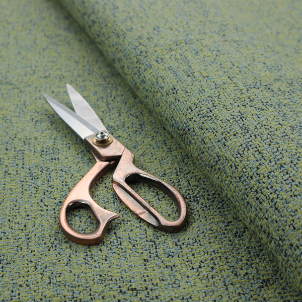 A textured moss green and teal woven upholstery fabric swatch.