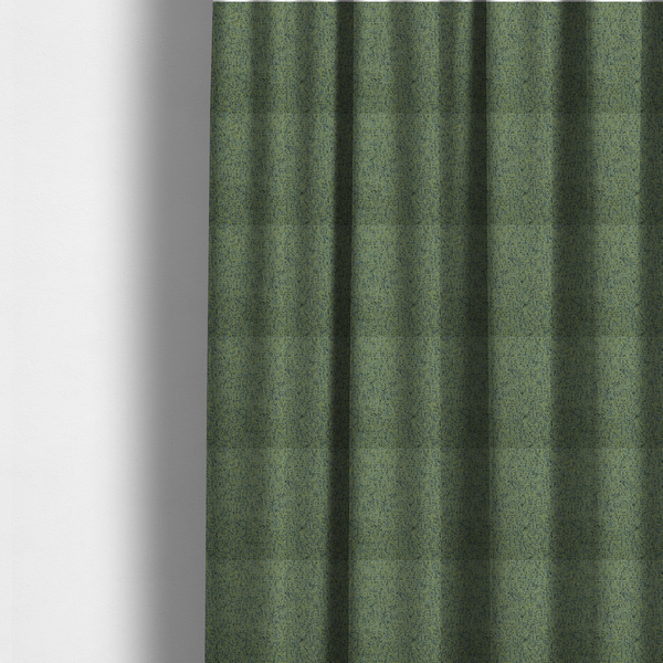 The fabric used to create these made-to-measure curtains is a textured moss green and teal woven upholstery fabric swatch.